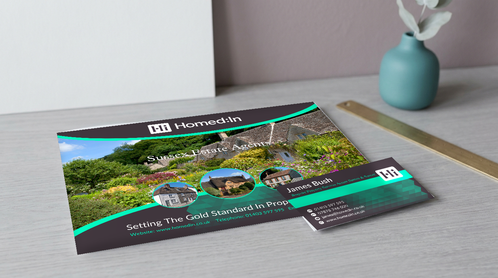 A Homed:In property brochure and business card designed by PWDP, lying on a studio desk